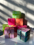 Eight Infinity Cube 3d Print toys (in various colors) stacked in a pyramid shape.