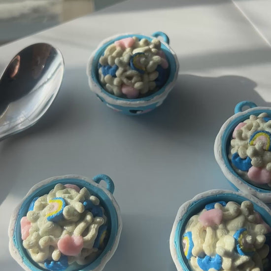 Hand clicking Lucky Charms cereal bowl fidget clicker.