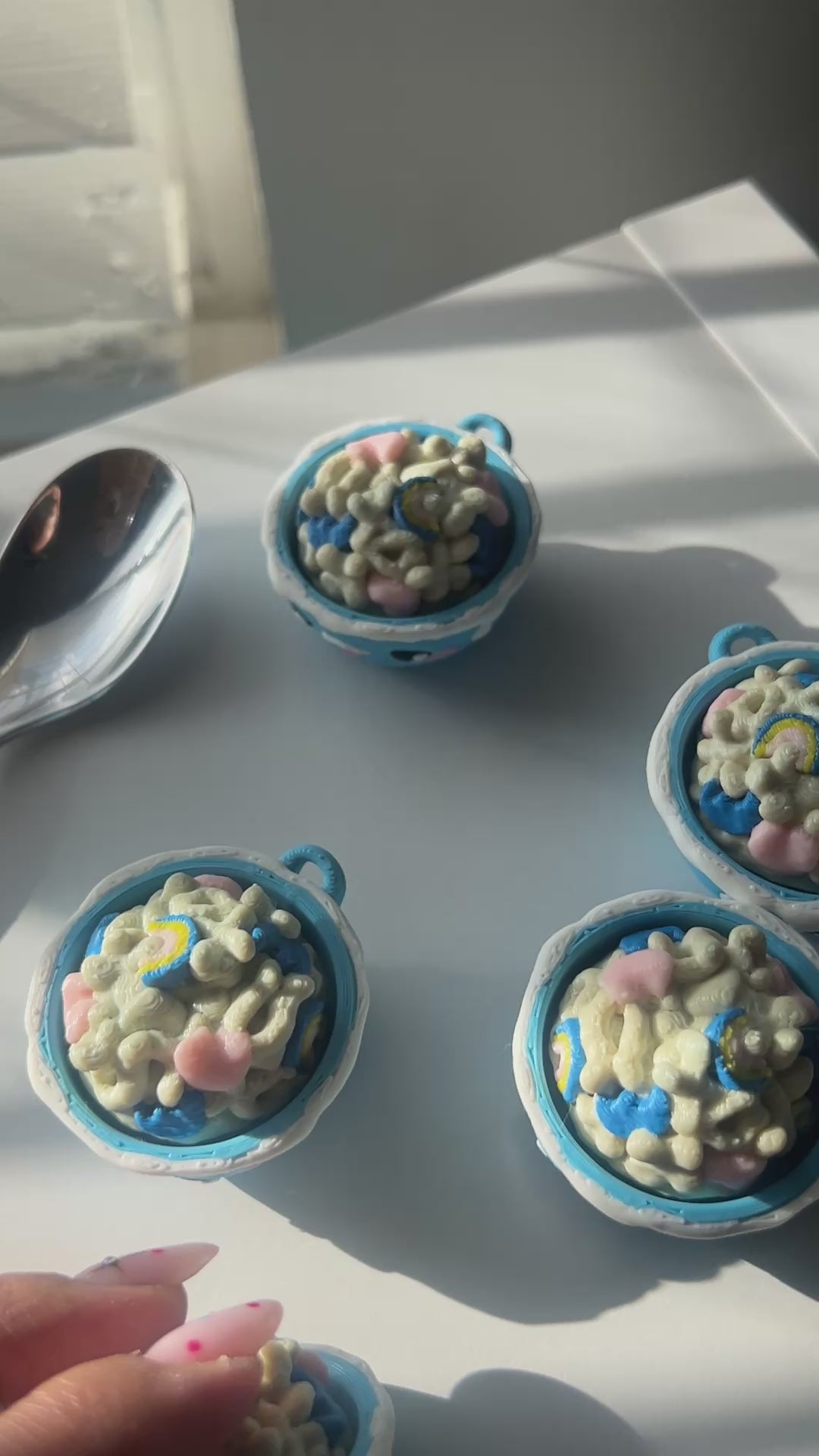 Hand clicking Lucky Charms cereal bowl fidget clicker.