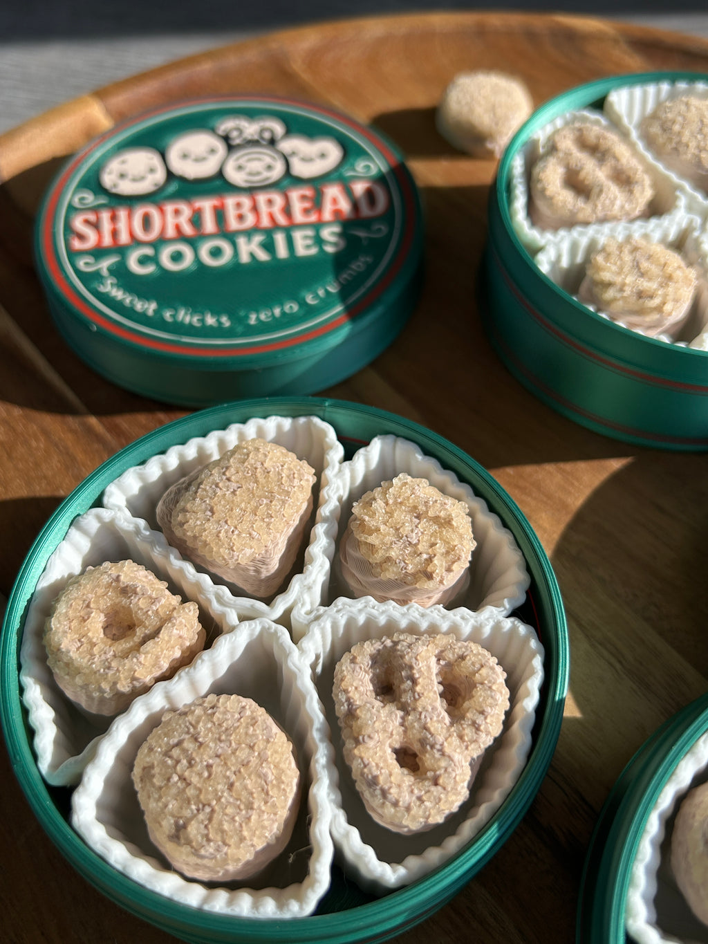 Open containers of shortbread cookies on a wooden surface