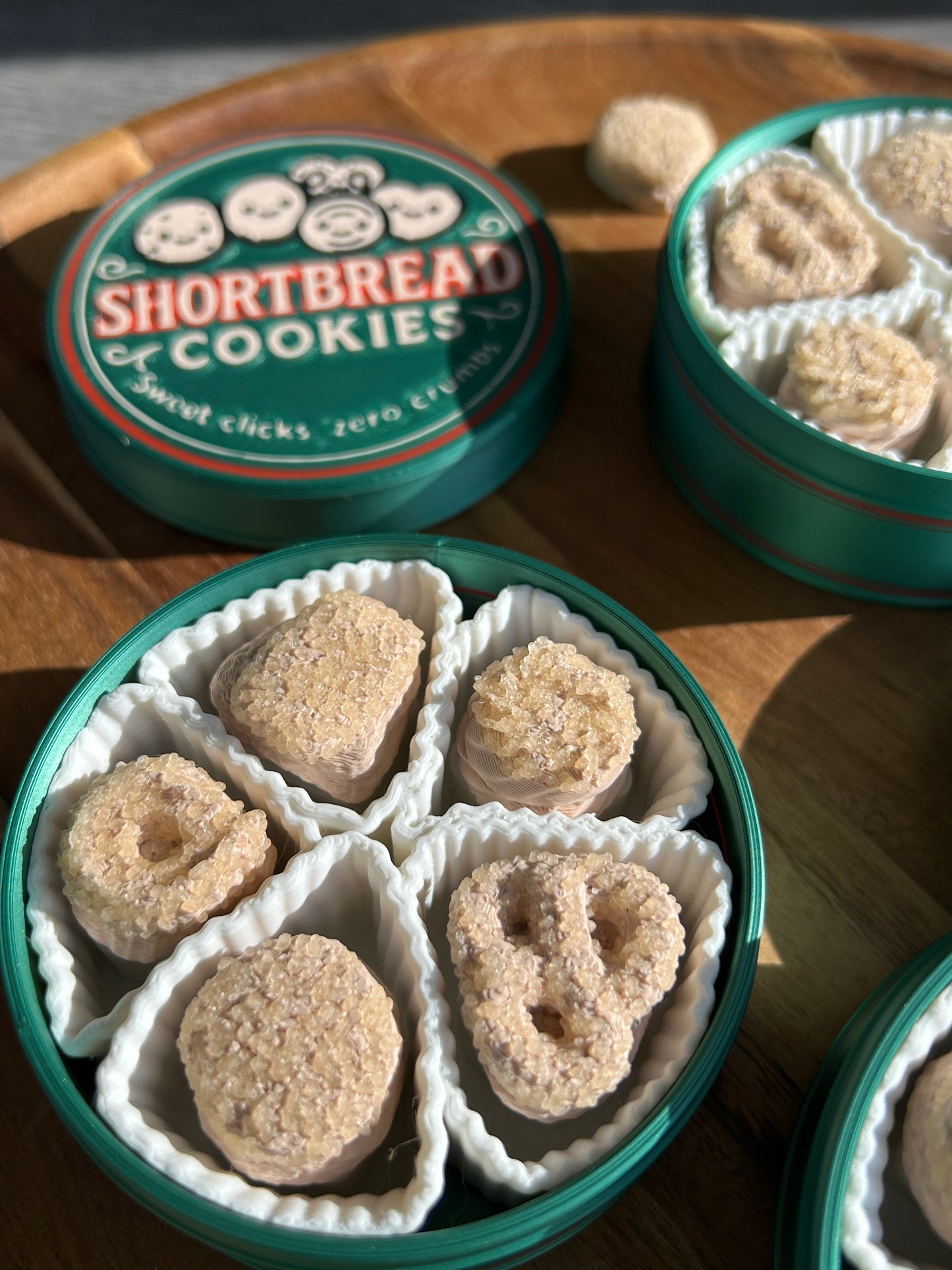 Open containers of shortbread cookies on a wooden surface